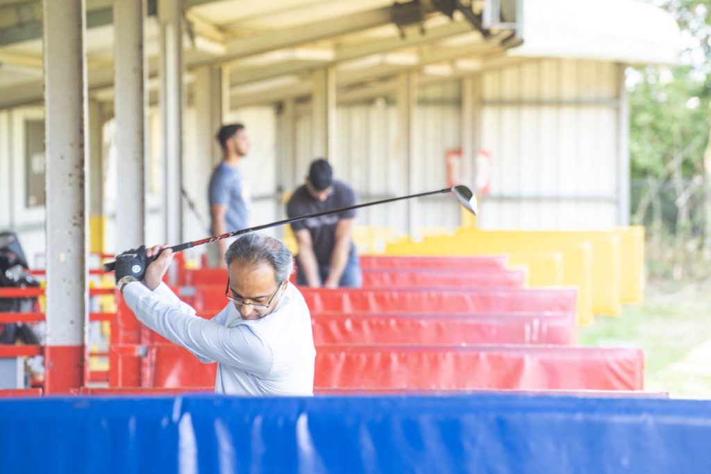 Golfers practising in the covered bays